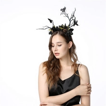 Detail showing Gothic antler headband with black flowers and butterfly decor on model