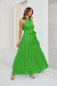 Detail view of the green tiered maxi dress showing the textured fabric and waist tie