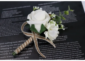 Detail of white PE rose boutonniere with green leaves and jute rope wrapped stem