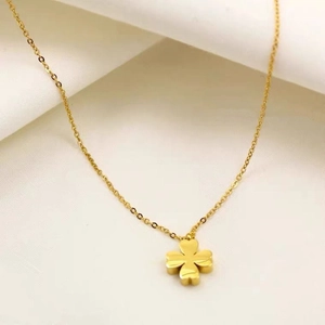 Detailed view of 18K gold plated four-leaf clover pendant on a delicate cable chain