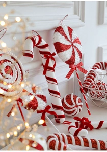 Close-up of red and white foam Christmas candy ornaments with glitter and velvet bows