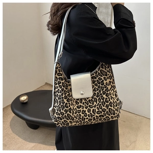 Detail of the leopard print fabric and silver leather flap with metallic round clasp