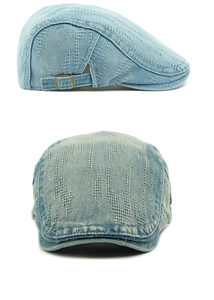 Close-up of light blue washed denim ivy cap with jacquard texture and metal buckle