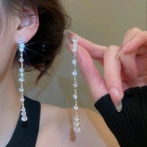 Macro view of silver tassel earrings with gradient cubic zirconia rhinestones