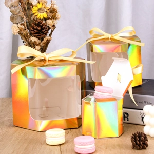 Detail of hexagonal kraft favor box with laser rainbow finish and yellow silk ribbon