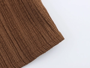 Macro shot of brown ribbed knit fabric texture on this two-piece beach vacation set