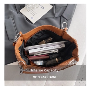 Macro view of spacious brown tote bag interior with tablet and cosmetics storage