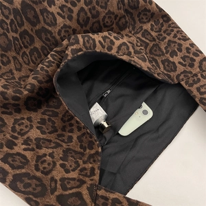 Close-up of leopard print tote bag with black lining and secure interior zipper pocket