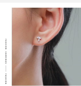 Detail of S925 silver mushroom stud earring with pink and clear cubic zirconia on ear