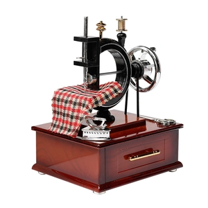Vintage European sewing machine music box with brown wooden base and red checkered cloth