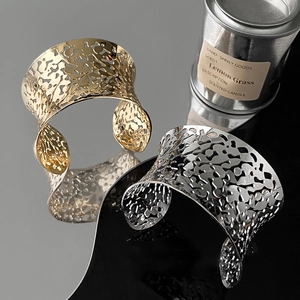 Wide hollow metal cuff bracelets in gold and silver finish with organic wavy edges