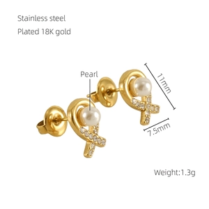 Detail of 18K gold plated stainless steel stud earrings with pearl and small rhinestones