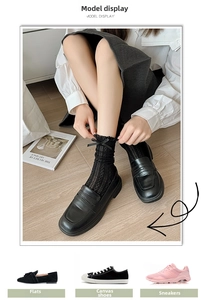 Detail of black lace crew socks with bow and mesh texture worn with leather shoes