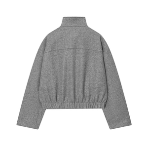 Detail view of the back of a gray fleece bomber jacket with ribbed hem and high texture