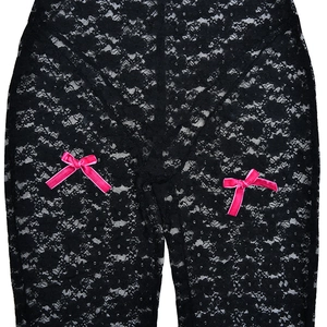 Close-up of black lace fabric with intricate floral patterns and pink velvet bows
