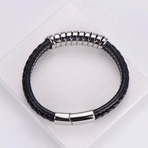 Men's double-braided black leather bracelet with silver magnetic clasp on white stand
