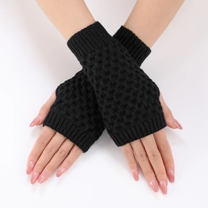 Close-up of black cable knit fingerless gloves with ribbed cuffs on hands