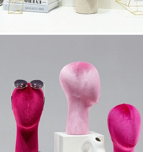 Detailed view of pink velvet mannequin heads used for display of hats and eyewear accessories