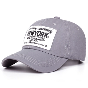 Detail of grey cotton baseball cap with New York patch and vintage stitched brim