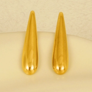 Macro close-up of gold-toned 304 stainless steel teardrop earrings with a glossy mirror finish