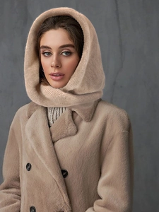 Detailed close-up of apricot plush fabric on winter hooded scarf coat with buttons