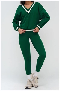 Detail of V-neck striped collar and athletic knit fabric on deep green sweatshirt