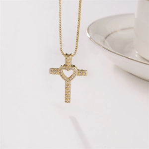 Golden cross necklace with heart pendant and sparkling cubic zirconia on box chain