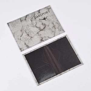Detail view of marble pattern passport holder with internal card slots and gray finish