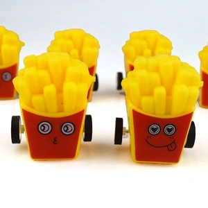 Close-up of plastic french fries toy cars with cute cartoon expressions and black wheels