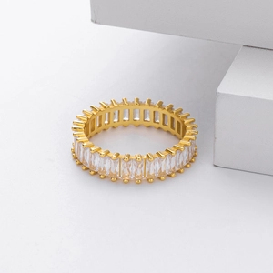 Macro shot of gold eternity ring featuring rectangular clear cubic zirconia stones
