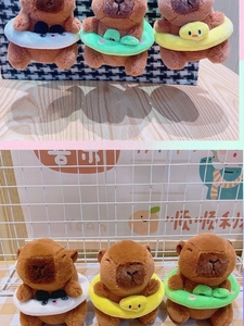 Macro detail of plush capybara charms with colorful swimming rings and cute embroidery