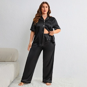 Women's black faux silk pajama set with white piping, short sleeve top and long pants
