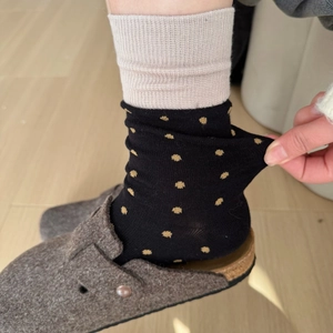 Detail of stretchable vintage polka dot crew socks with beige rib and gold dots