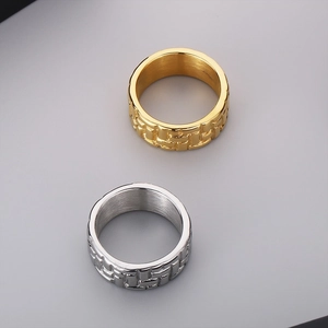 Macro detail of geometric woven texture on gold and silver stainless steel rings
