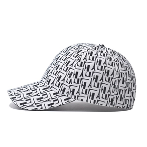Detail of baseball cap showing black H and A letter patterns and Eiffel Tower motifs