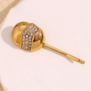 Detailed macro view of gold-plated hair clip featuring sparkling rhinestone bands