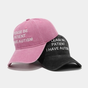 Pink and black retro baseball caps with 'PLEASE BE PATIENT I HAVE AUTISM' embroidery