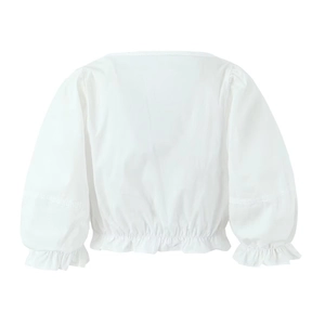 Detail of white puff sleeve blouse featuring elastic waist and ruffled hemline