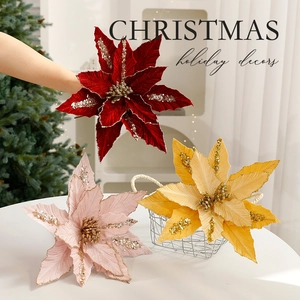 Glittery artificial Christmas poinsettia flowers in red, pink and gold holiday decor