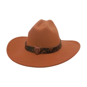 Detail of camel brown felt cowboy hat featuring an antique bronze leopard head buckle