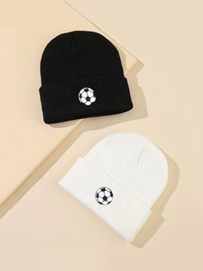 Detailed view of black and white beanies with embroidered football patches on ribbed knit