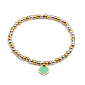 Detail of 4mm tricolor metal beads bracelet with green heart enamel charm on white background