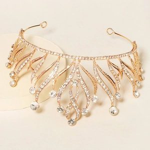 Detailed close-up of golden bridal tiara with sparkling rhinestones and crystal fringe