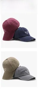 Detail view showing four colors of cotton baseball caps with white heart embroidery