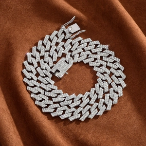Detailed view of silver-tone 15mm iced-out Cuban link chain with square lobster clasp