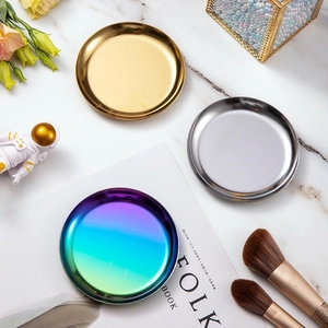 Macro detail of round stainless steel trays in gold, silver, and iridescent finishes