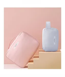 Detail of pink and blue waterproof makeup bags with MAKEUP BEAUTY label on soft steps