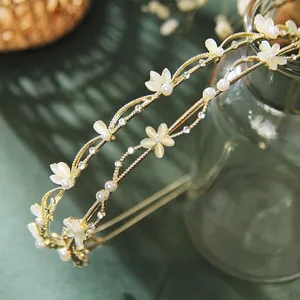 Elegant French leaf headband set with white cat eye flowers and pearls on golden metal