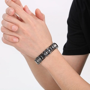 Close-up of industrial silver stainless steel bracelet with black carbon fiber inlay