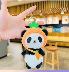 Detail of cute panda plush keychain wearing a creative carrot hat and a mini cross-body bag